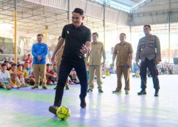Wakil Ketua AFK Siantar Sertu Ahmad Fadhil Siregar melakukan tendangan pertama pembukaan Turnamen Futsal Remaja Mesjid Cup Tahun 2023