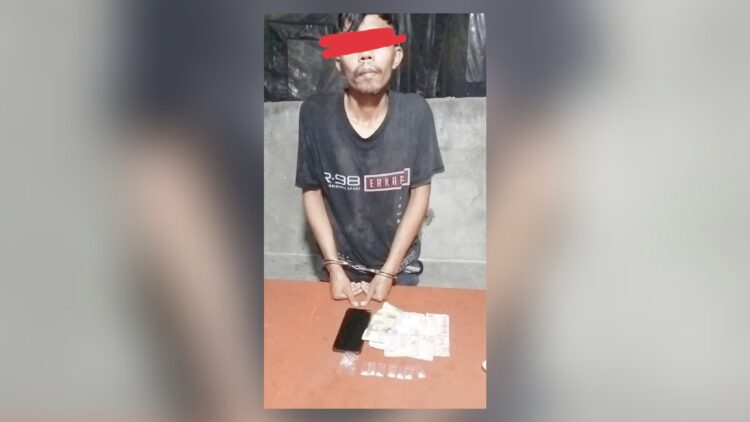 Tersangka Romi Afandi Simatupang dan barang bukti