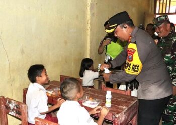 Kapolres Nias AKBP Revi Nurvelani menyalurkan bantuan di SDN 078481 Uluna’ai Hiligodu, Kecamatan Idanogawo, Nias. (Foto Ist)