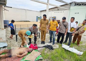Personil piket Polsek Tanah Jawa menyaksikan pemeriksaan luar jenajah Josep Sihite