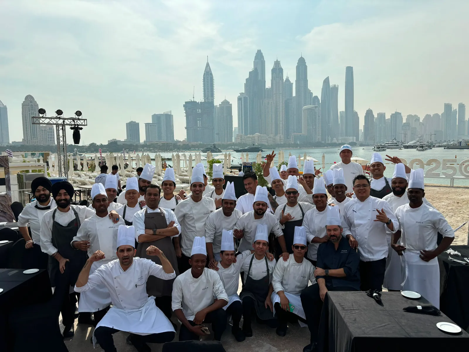 Chef Bobby Sutanto with a hotel kitchen brigade overlooking Dubai Marina