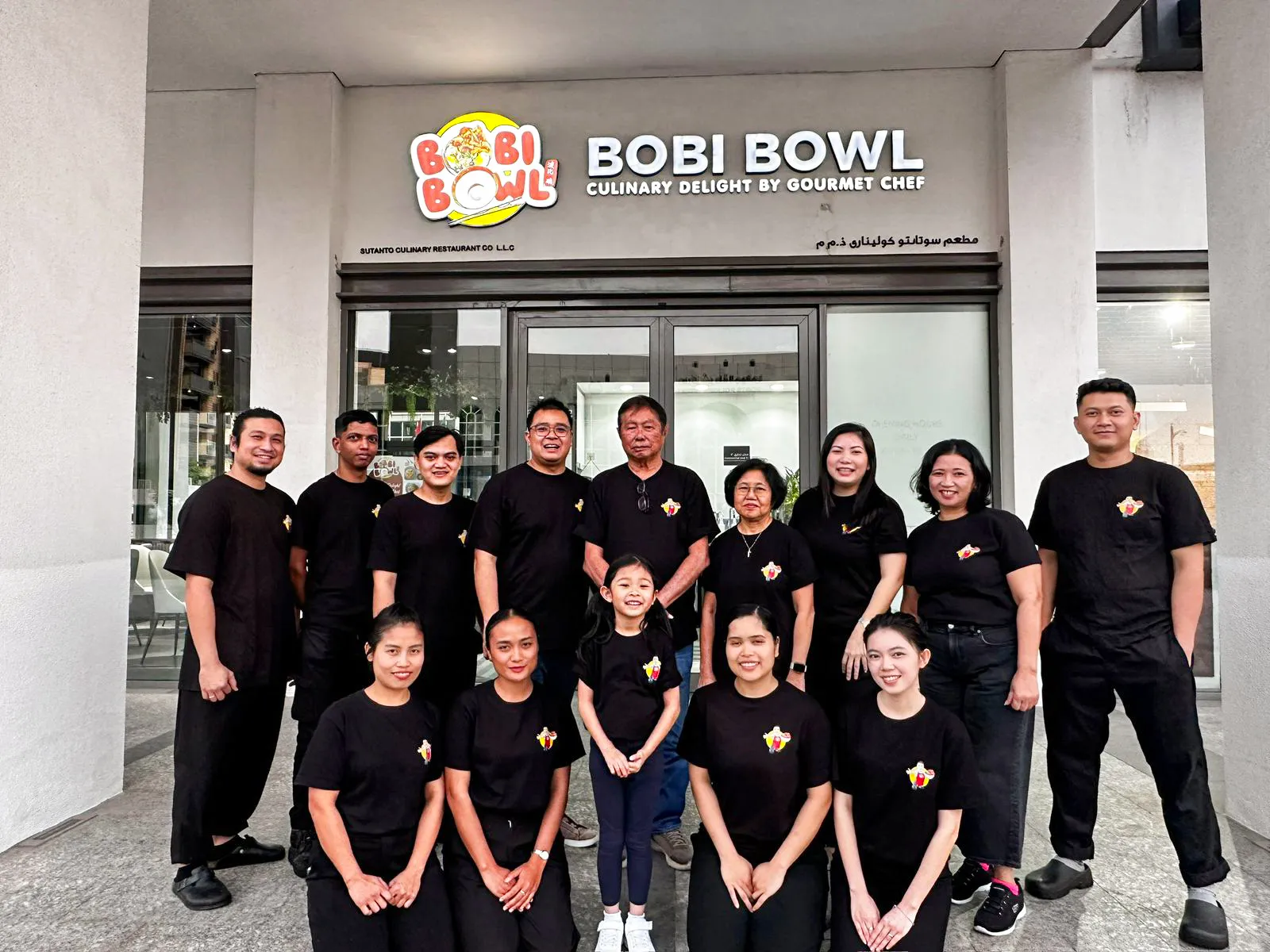 The Bobi Bowl team in front of the restaurant at Wasl Port Views