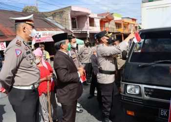 Kapolres Dairi AKBP Wahyudi Rahman, SH, S.I.K, MM bersama Forkopimda dan Personil Polres Dairi serta Polsek Jajaran membagikan Bendera Merah Putih