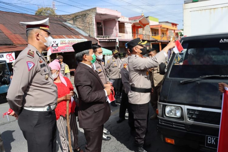 Kapolres Dairi AKBP Wahyudi Rahman, SH, S.I.K, MM bersama Forkopimda dan Personil Polres Dairi serta Polsek Jajaran membagikan Bendera Merah Putih