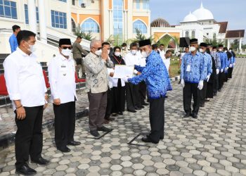 Penjabat Bupati Aceh Utara Azwardi, AP, MSi, mendampingi Sekda Provinsi Aceh menyerahkan SK kenaikan pangkat dan SK pensiun untuk 143 orang Apratur Sipil Negara (ASN)