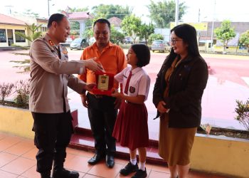 Kapolres Dairi AKBP Wahyudi Rahman, SH, S.I.K,MM Berikan penghargaan Plakat Polres Dairi sebagai motivasi kepada Alena Richelle Pardosi siswa kelas 5 SD Santo Yoseph Sidikalang