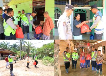 Kapolres Labuhanbatu, AKBP James H. Hutajulu, SIK., SH., MH., MIK. memberikan bantuan sembako kepada masyarakat yang menjadi korban banjir di Jalinsum Kel. Bandar Durian