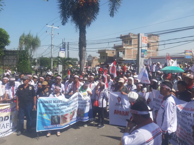 Ribuan orang yang tergabung dalam Aliansi Masyarakat Sumatera Utara melakukan aksi demo di depan Mapolda Sumut, Selasa (25/7/23) sekira pukul 09.00 WIB