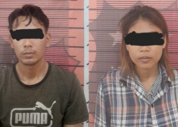 DIAMANKAN : RM dan RIL, Pasutri terduga pelaku penggelapan mobil diamankan di Satreskrim Polres Sergai, (Foto Dok/ Polres Sergai)
