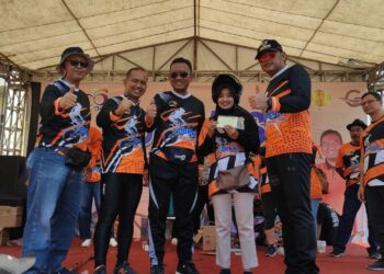 Titin Yuliana (40), warga Jl. Depo Rt 02/07 Kelurahan Panggung, Tegal Timur, Kota Tegal dengan wajah bahagia menerima helm dan kunci satu unit sepeda motor hadiah utama yang diserahkan oleh Wali Kota Tegal, H. Dedy Yon Supriyono, Danlanal Tegal, Letkol Laut (P) Adi Surono, Sekda Kota Tegal yang juga Plt. Direktur Rumah Sakit Umum Daerah (RSUD) Kardinah, drg. Dwi Agus Sulistyantono.