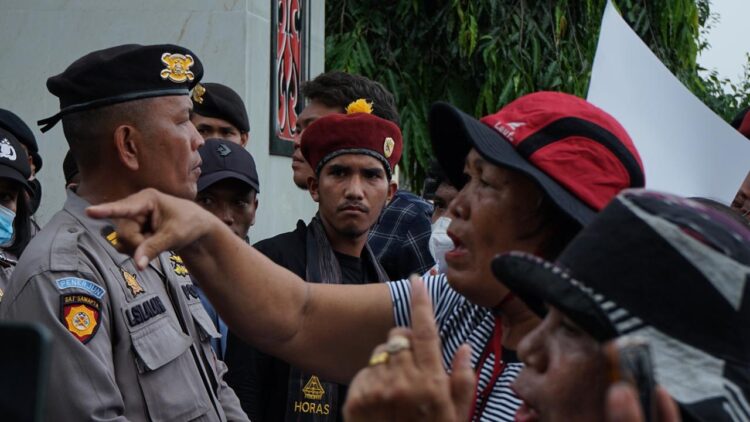 DIHADANG : Massa Aliansi Masyarakat Gerakan Tutup TPL dihadang barisan polisi yang berjaga di pintu masuk 2 Mapolda Sumut, Rabu (27/3/2024). (Foto Dok/ T77)