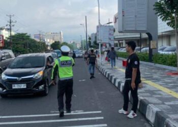 Satuan Lalu Lintas (Sat Lantas) Polresta Manado melakukan pengaturan lalu lintas yang efektif dan berhasil mengatasi kemacetan di jalan raya utama Kota Manado, Sulawesi Utara, Minggu (28/4/2024).