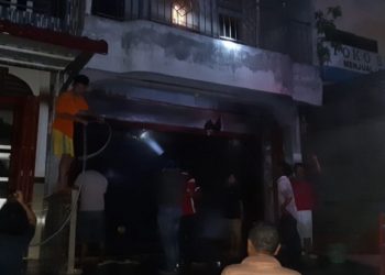 Petugas pemadam kebakaran saat berupaya memadamkan api yang membakar satu unit ruko di Terminal Pangururan, Samosir, Jumat (19/2/2021). (Foto: istimewa)