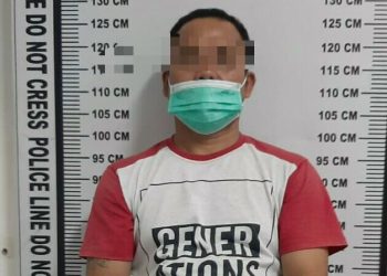 Foto tersangka saat di kantor polisi.