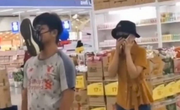 Pria di Taiwan menggunakan sepatu sebagai pengganti masker saat belanja di supermarket (Foto: Twitter)