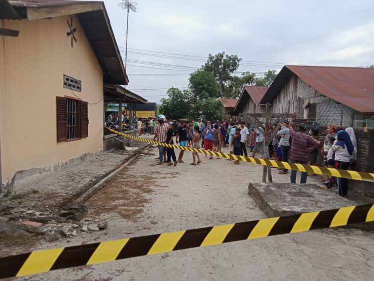 Petugas memasang garis polisi di lokasi kejadian.