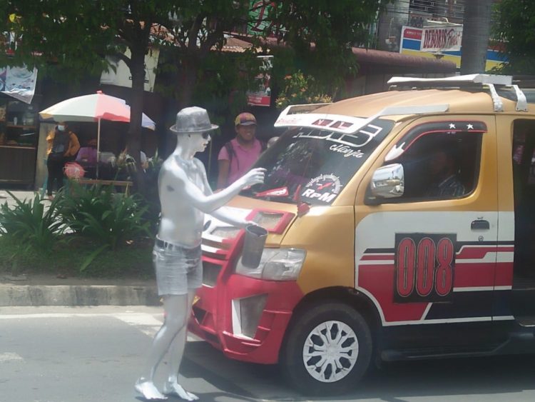 Andre saat menyapa para pengendara di lampu merah jalan Ahmad Yani Pematangsiantar.