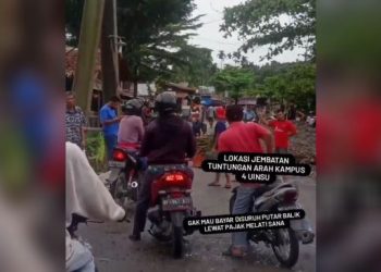 Tangkapan gambar aksi pria menutup jalan dan meminta uang ke masyarakat. [Ist]
