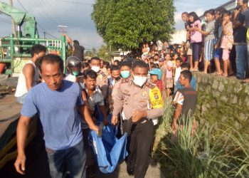 Petugas kepolisian mengevakuasi jasad korban.