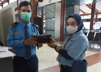 Petugas cleaning service Bandara Soetta, Tangerang menyerahkan dompet berisi cek Rp35,5 miliar yang dia temukan saat bertugas ke petugas berwenang, Jumat (29/10/2021). (Foto: Isty Maulidya).