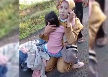Istri korban begal terus menggendong anaknya di samping suaminya yang terkapar ditembak begal di Lempuing OKI. (Foto: Ist)