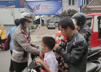 Kasat Lantas Polres Pematangsiantar, AKP Relina Lumbangaol S.Sos, ikut membagikan masker kepada pengendara yang tidak prokes.