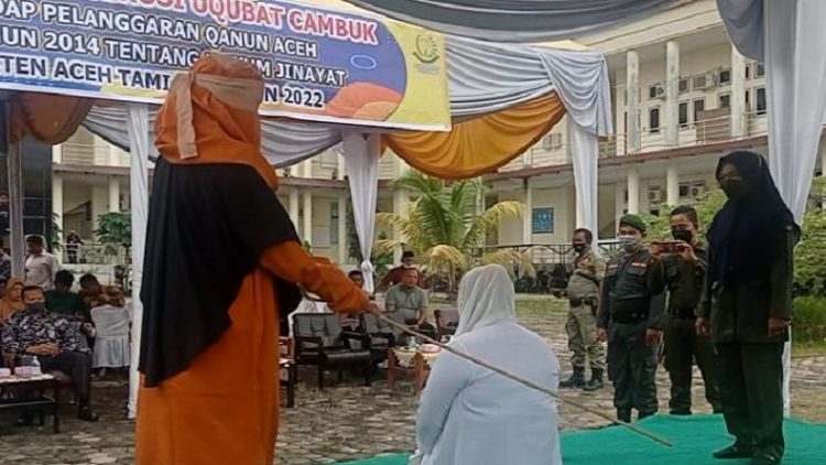 Algojo mengeksekusi cambuk terdakwa perempuan di Aceh Tamiang, Jumat (18/3/2022). (ANTARA/Dede Harison)