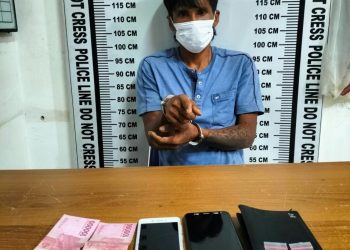 Foto pelaku menunjuk barang bukti dengan tangan diborgol.