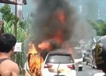 Satu unit mobil minibus terbakar ketika melintas di jalan Medan-Berastagi, Minggu (12/6/2022) pagi. HO