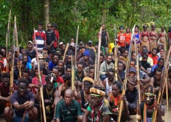 Ratusan warga menjaga kediaman Gubernur Papua, Lukas Enembe di Jayapura, Jumat (30/9/2022). Massa berjaga sambil menenteng senjata tradisional panah dan parang. Foto/iNews TV