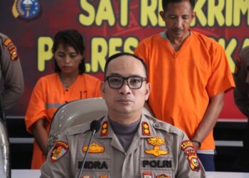 Pasangan suami istri ini hanya bisa tertunduk usai ditangkap jajaran Polres Bengkalis usai membakar orang gila di dalam mobil hingga tewas. Foto: MPI/Banda Haruddin Tanjung