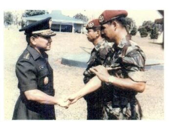 KSAD Jenderal TNI Rudini menjabat tangan Kolonel Sintong Panjaitan dalams erah terima jabatan Komandan Kopassandha dari Brigjen TNI Wismoyo Arimusnandar pada Mei 1985. Foto/Istimewa