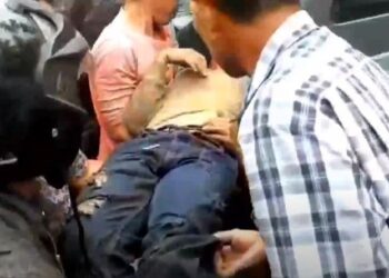Polisi dibantu warga saat mengevakuasi perempuan muda dalam kondisi pingsan penuh lebam yang ditemukan warga di semak-semak Desa Sei Lendir, Kecamatan Sei Kapayang, Kabupaten Asahan, Sumatera Utara. (Foto : iNews/Ulil Amri)
