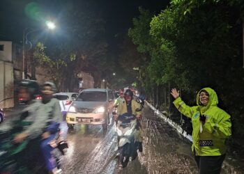 Kasat Lantas Polres Pematangsiantar, AKP Gabriellah A. Gultom, SIK, MH, pimpin pengaturan (Gatur) arus lalulintas (Lalin) menyusul terjadi banjir yang menyebabkan kemacetan.