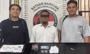 Tersangka dan barang bukti diapit petugas