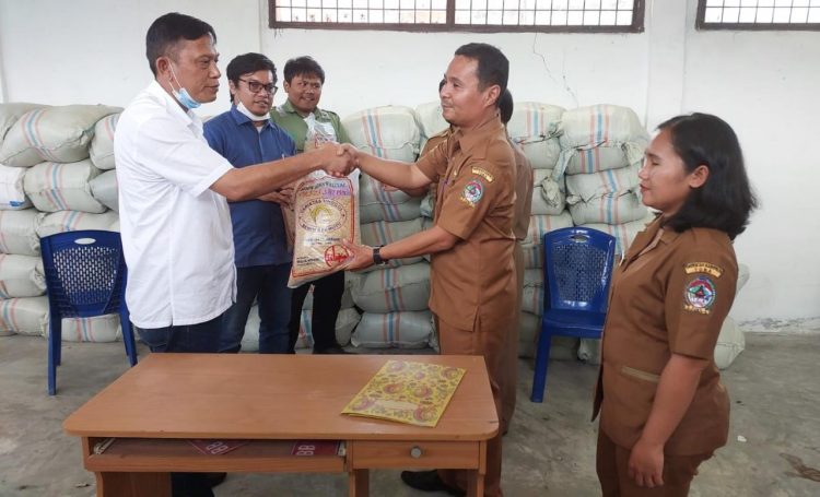 Koordinator Stakeholder Relation Mill (SHRM) PT TPL, Jerry Tobing, menyerahkan bibit padi kepada perwakilan Dinas Pertanian Toba untuk nantinya dibagikan kepada petani.