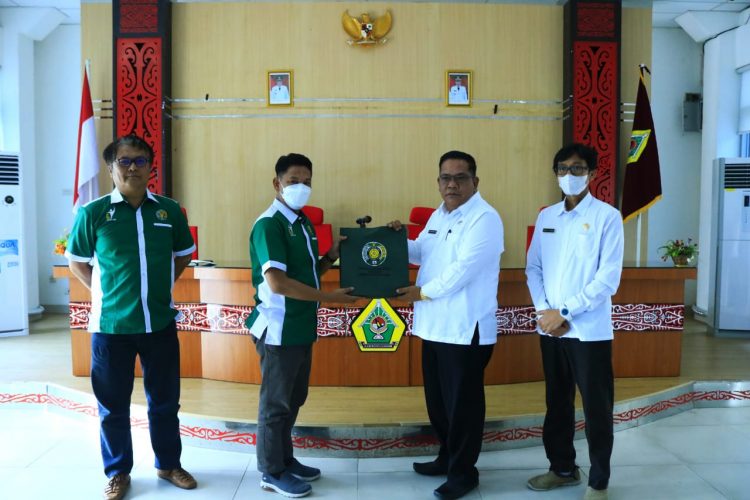 Sekdakab Samosir bertukar cindremata dengan perwakilan USU saat menerima mahasiswa yang akan KKNT di Samosir.