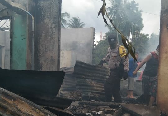 Personel Polsek Dolok Batu Nanggar, sedang melakukan olah TKP di lokasi kebakaran di Jalan YMI Kelurahan Sinaksak, Kecamatan Tapian Dolok.